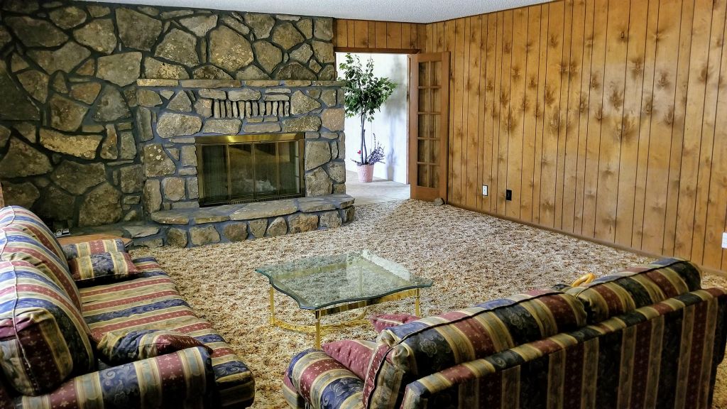 Living Room with Native Stone Wood Buning Fireplace